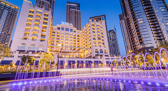 Vida Creek Harbour at twilight with illuminated fountain